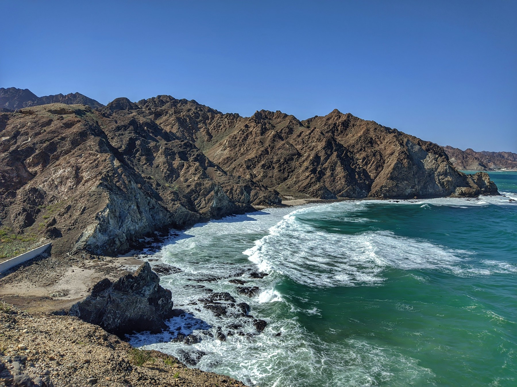Turquoise water and rugged cliffs along the coast of Muscat, Oman